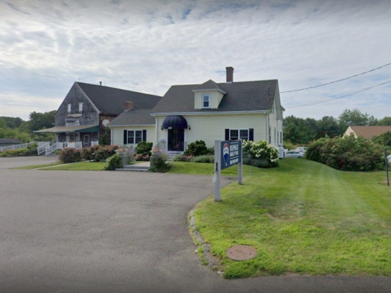 A quaint office building with RE/MAX sign outside