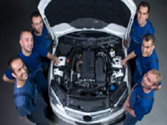 Team of mechanics inspecting engine