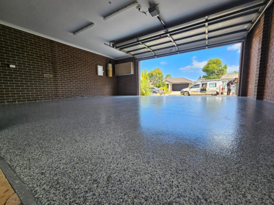 Clean garage with speckled floor and open door