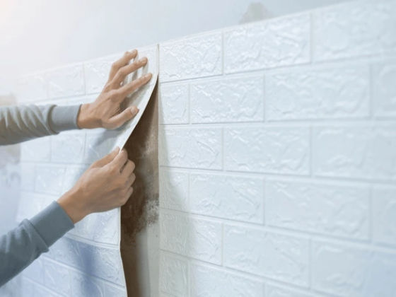 Hands removing wall tile peel for renovation