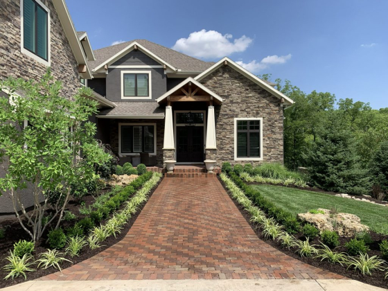 Stylish stone house with manicured garden entrance