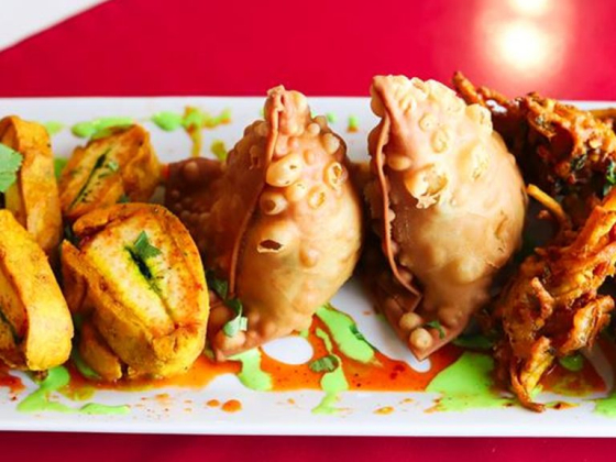 A variety of Indian appetizers served on a white plate