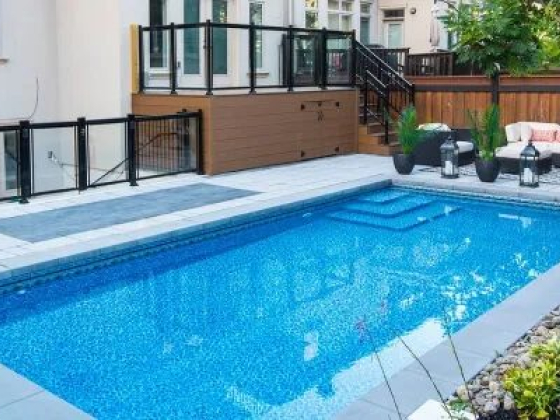 Modern backyard featuring a pool and stylish patio furniture
